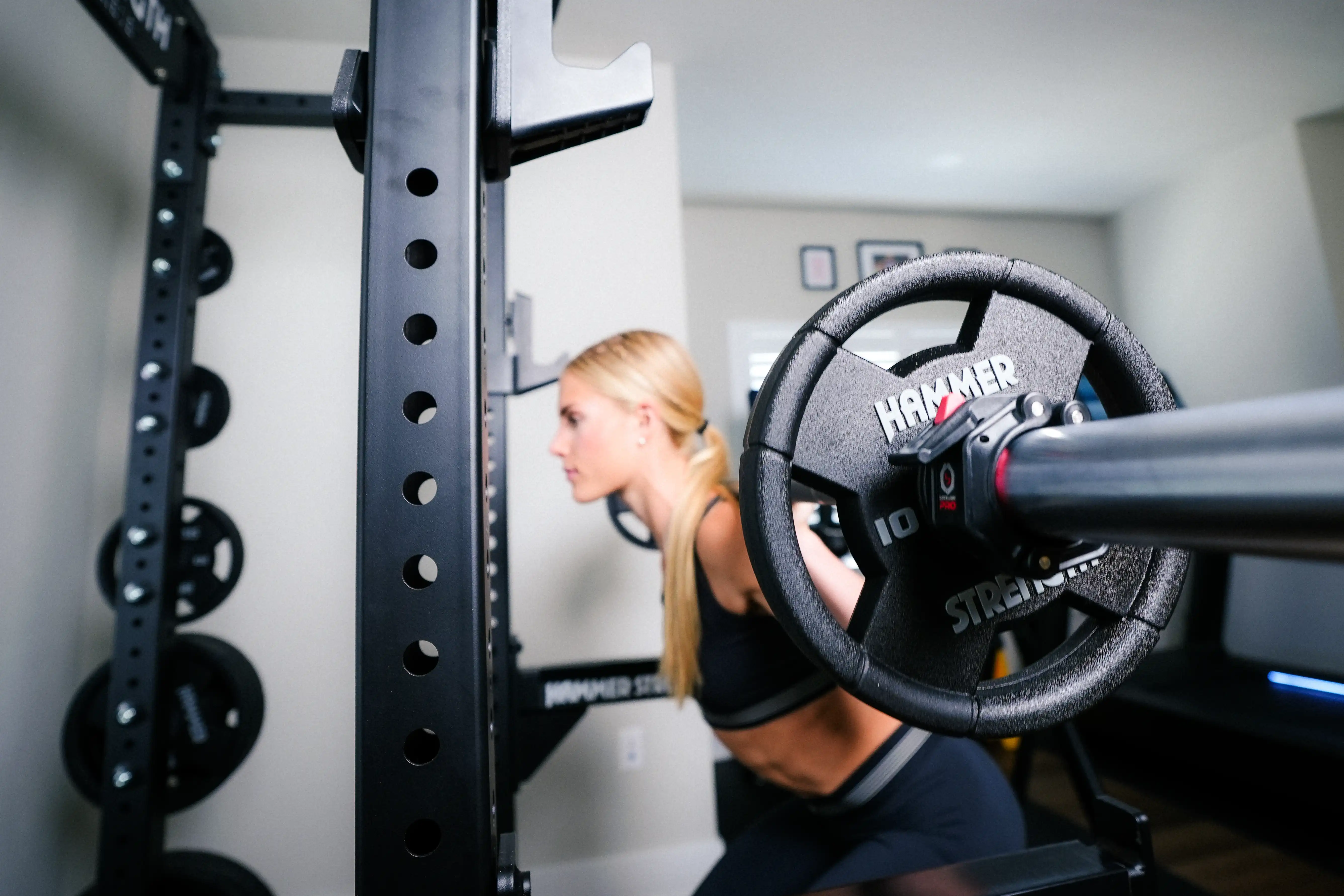 Woman Squatting with Hammer Strength Rack